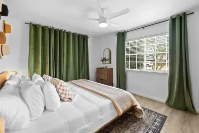 Relax in the spacious bedroom featuring a luxurious king-sized bed, designed for ultimate comfort. The room offers a serene atmosphere, with elegant décor and ample space for a restful night’s sleep in a peaceful retreat.