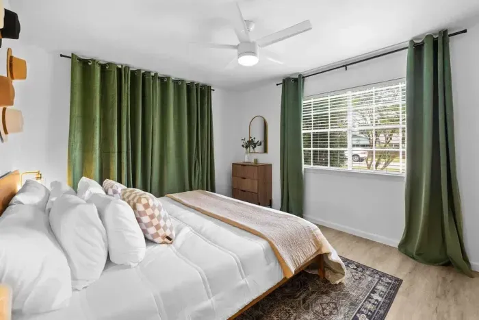 Relax in the spacious bedroom featuring a luxurious king-sized bed, designed for ultimate comfort. The room offers a serene atmosphere, with elegant décor and ample space for a restful night’s sleep in a peaceful retreat.