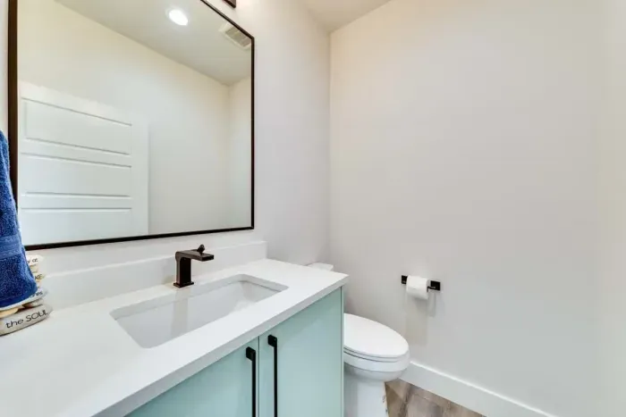 Fresh and stylish bathroom with a large vanity and natural light.