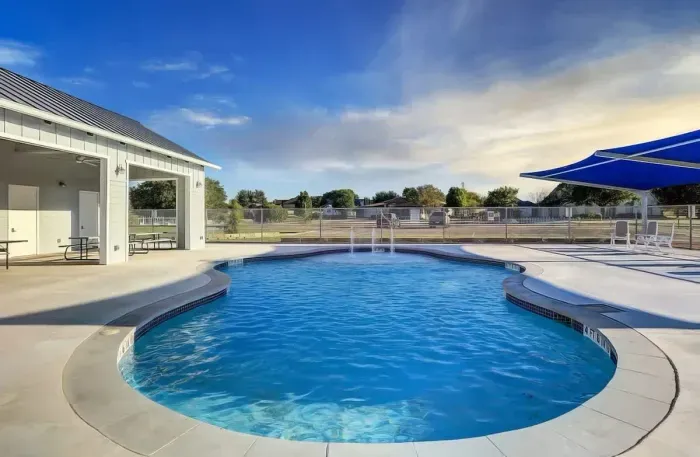 Gorgeous pool area with plenty of seating and shaded area.