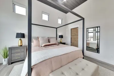 Spacious primary bedroom with a king-sized bed and an en-suite bathroom.