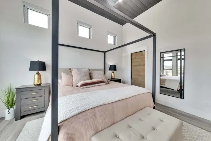 Spacious primary bedroom with a king-sized bed and an en-suite bathroom.