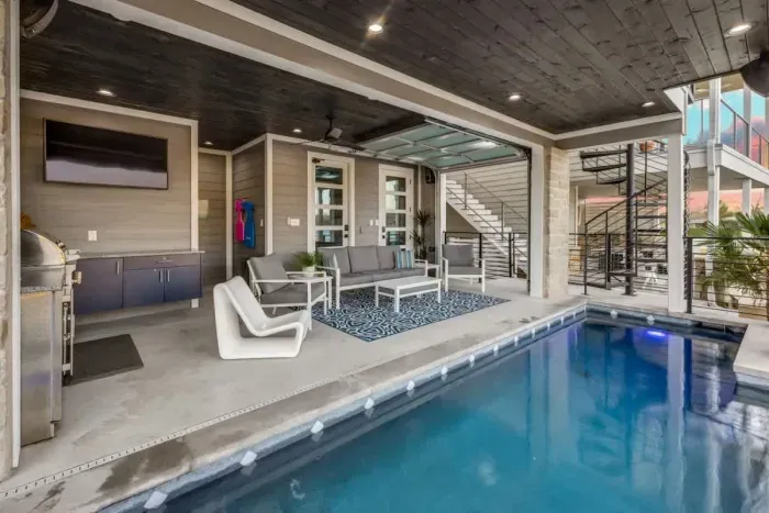 Escape the hustle and bustle in our backyard paradise, where the pool beckons you to relax.