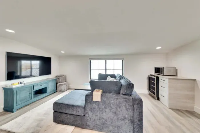 Unwind in this cozy loft featuring a plush sectional, big-screen TV, and a convenient kitchenette; your perfect retreat!