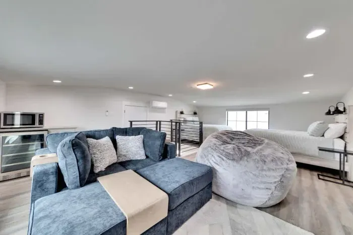 Relax in this stylish loft with cozy seating, plush bedding, and a convenient kitchenette; perfect for a comfortable stay!