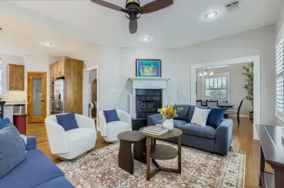 Bright and airy lounge area with stylish décor and ceiling fan.