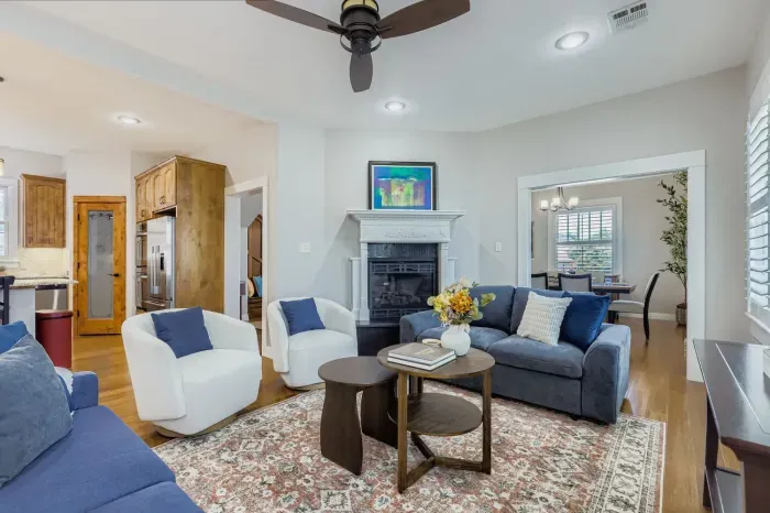 Bright and airy lounge area with stylish décor and ceiling fan.