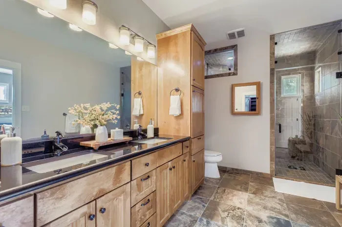 Spa-inspired bathroom with dual sinks and glass shower.