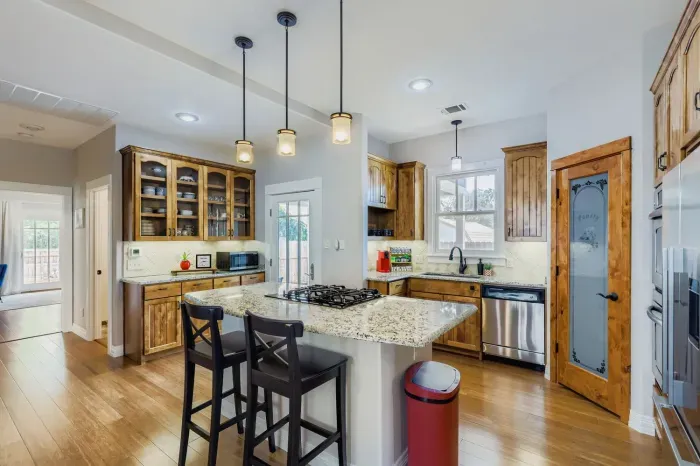 Gourmet kitchen with island seating and stainless-steel appliances.