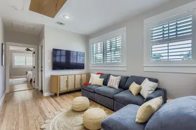 Entertainment room with sectional sofa and mounted TV.