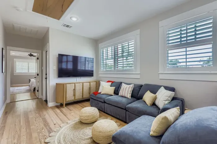 Entertainment room with sectional sofa and mounted TV.