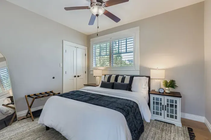 Calm guest room with queen bed and classic details.