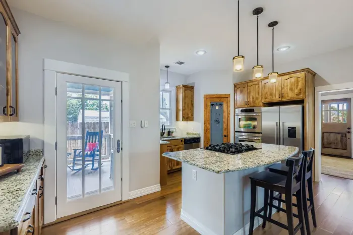 Chef’s kitchen with granite countertops and ample storage.