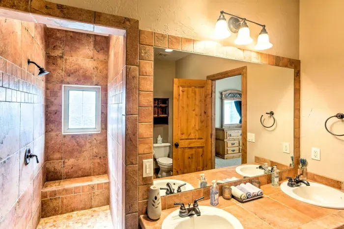 Spacious bathroom with dual sinks and a large mirror for added convenience.