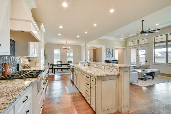 Chef’s kitchen with granite counters and ample storage space.