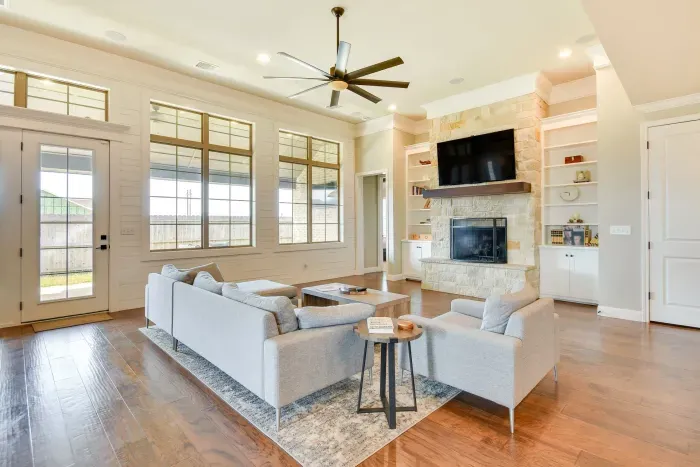 Spacious living room with elegant decor and large windows.