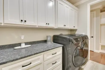 Convenient laundry room with washer, dryer, and folding counter