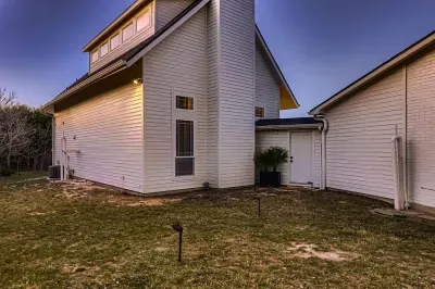 Spacious front yard with beautiful greenery and inviting entry.