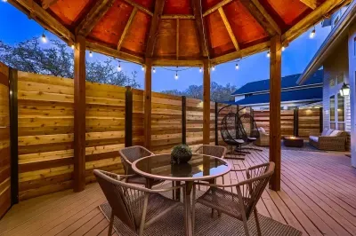 Cozy covered patio with string lights, perfect for evening drinks and relaxing conversations.