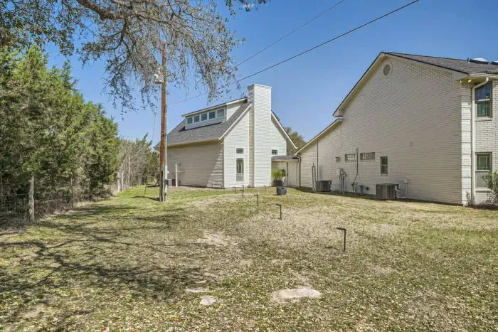 Inviting front yard with mature trees, a lovely garden, and a peaceful atmosphere.