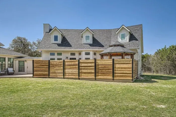 Escape to the spacious backyard, offering a peaceful retreat with outdoor seating and room to relax under the open sky.