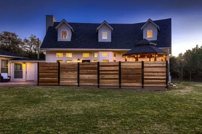 Spacious back yard with beautiful greenery and inviting entry.