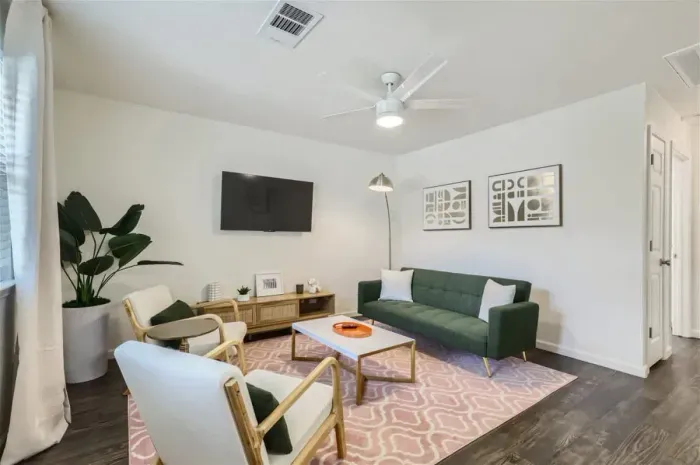 Charming living room with a neutral palette and pops of color for a stylish retreat.