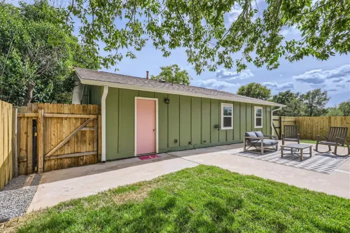 4. Beautifully landscaped backyard with a combination of greenery, flowers, and a peaceful atmosphere.