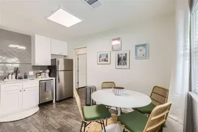 5. Open kitchen and dining area designed for both style and functionality. The modern kitchen features sleek appliances and ample counter space, while the dining area offers a perfect spot for family meals or entertaining.
