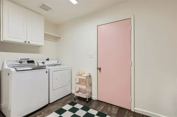 Spacious laundry room with washer and dryer for your convenience.