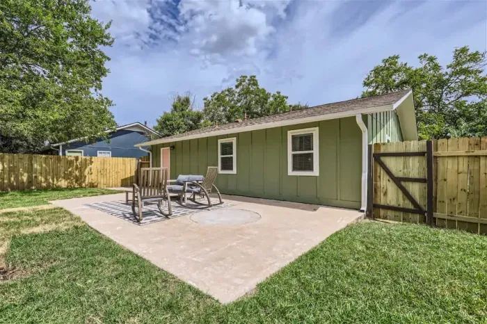 Spacious backyard with a lush lawn, perfect for outdoor games, relaxation, and barbecues.