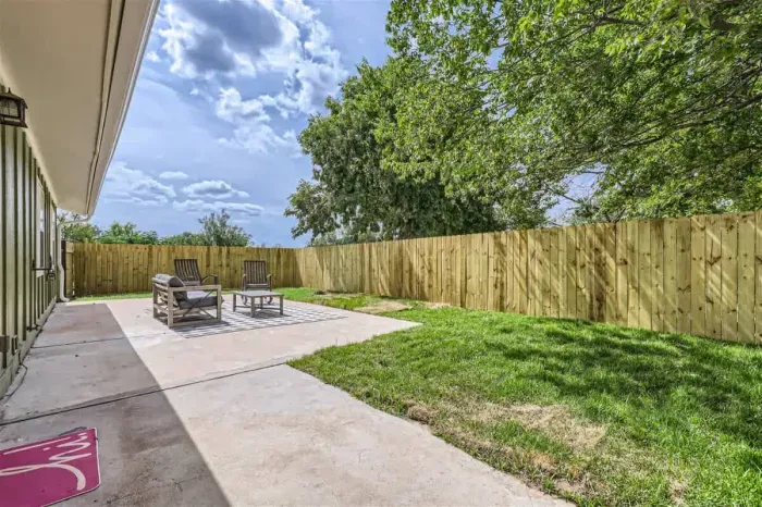 Family-friendly backyard with a play area, plenty of green space, and outdoor seating.