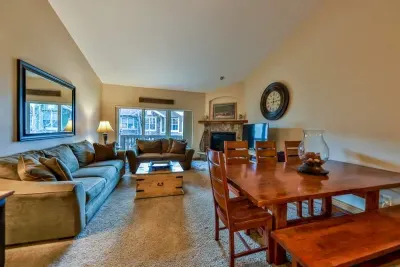 After a day on the slopes, relax by the fireplace, sink into the comfy sofa, and share meals around the rustic dining table.