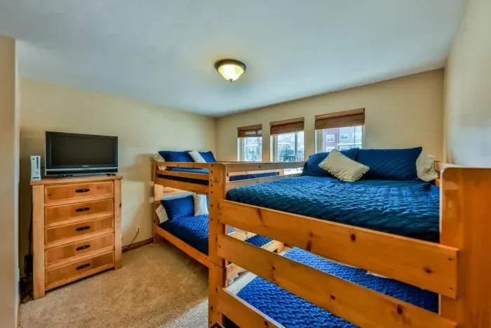 Enjoy the spacious bedroom featuring two double deck beds, offering plenty of sleeping space for family or guests. Perfect for children or group stays, the room provides comfort and convenience with a fun, shared sleeping arrangement.