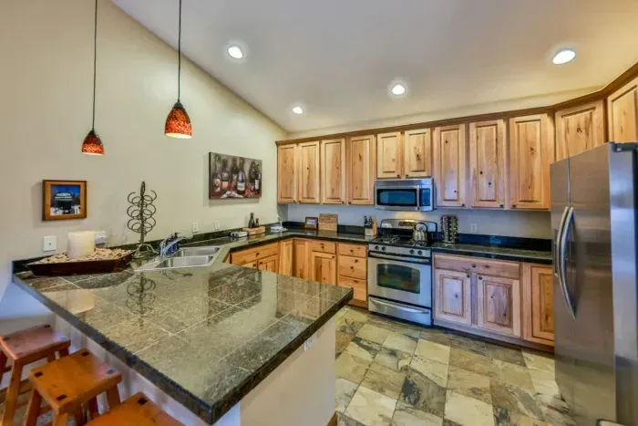 Spacious kitchen with a large island and seating, ideal for enjoying morning coffee or group meal prep.
