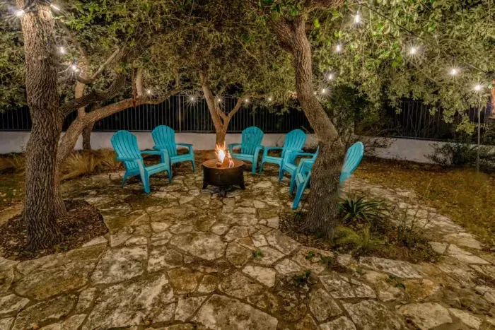 Private backyard oasis featuring a large deck, comfy seating, and a fire pit for cozy evenings.