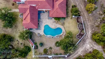 Unwind in your private backyard retreat, complete with a serene pool and lush landscaping.