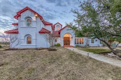 Timeless and elegant home with classic architectural details and a lush front lawn.
