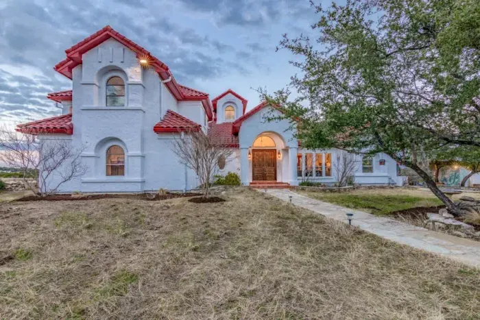 Timeless and elegant home with classic architectural details and a lush front lawn.