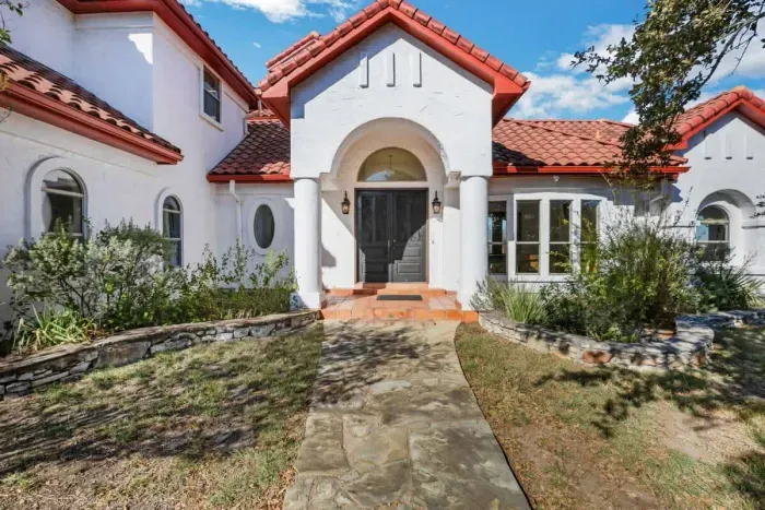 Welcoming home with an inviting front door and a beautiful garden path.