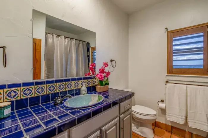 Bright and airy bathroom with plenty of counter space and stylish decor.