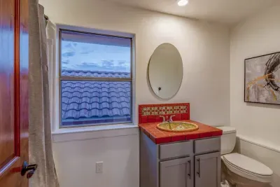 Bright and airy bathroom with plenty of counter space and stylish decor.
