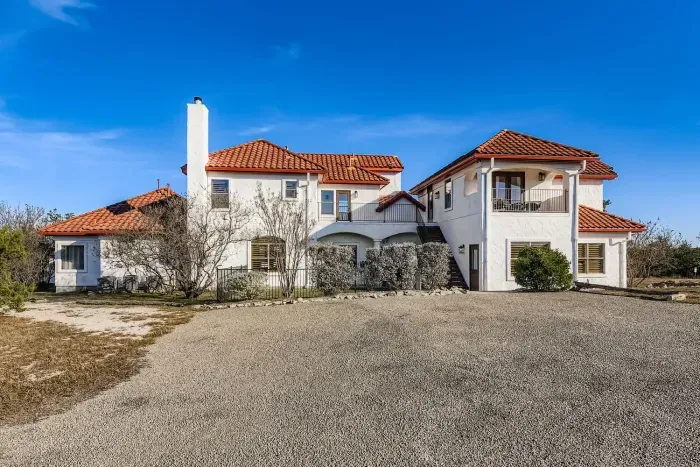Spacious backyard and driveway view.