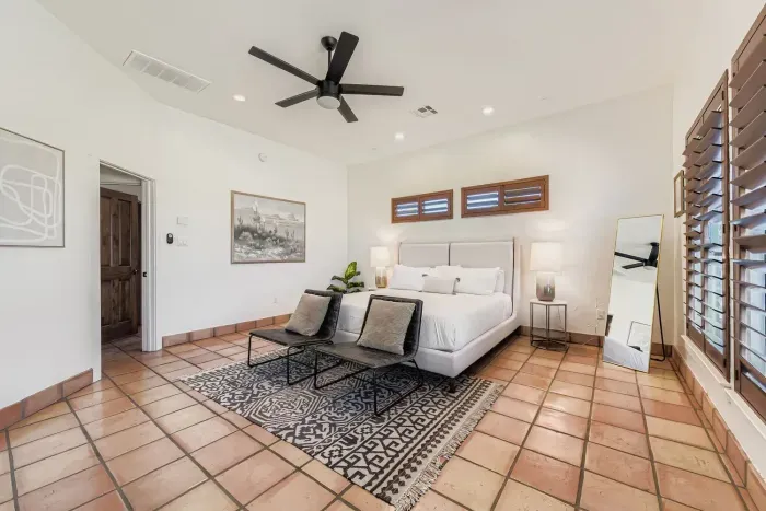 Primary bedroom with comfy seating area.