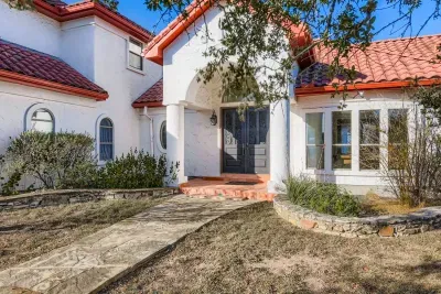 Front exterior with Spanish style architecture.