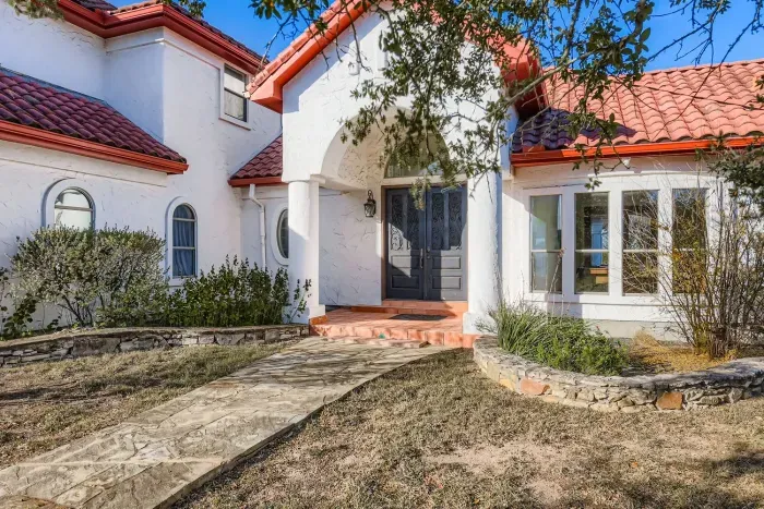 Front exterior with Spanish style architecture.