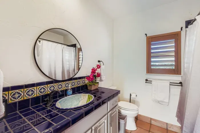 Bathroom vanity with tiled sink.