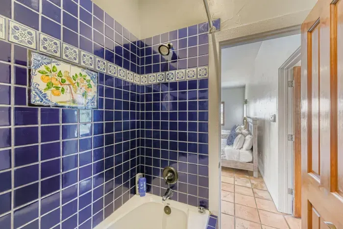 Full bathroom with tiled shower.