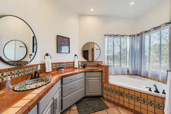 Bright bathroom with dual vanity.