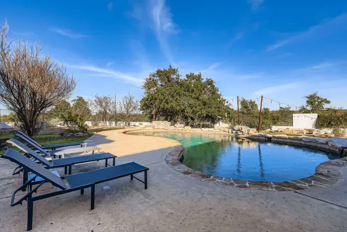 Pool area with lounge chairs.
